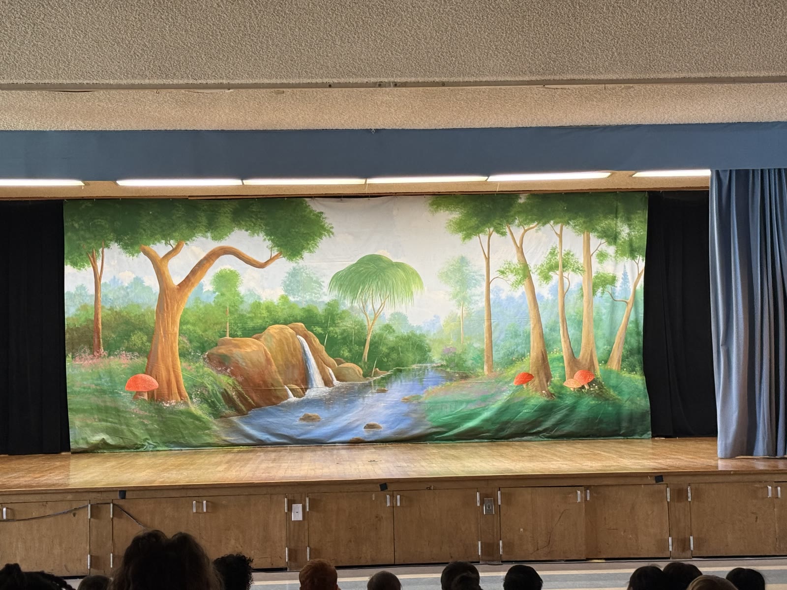 Student-painted forest set for Peter Pan