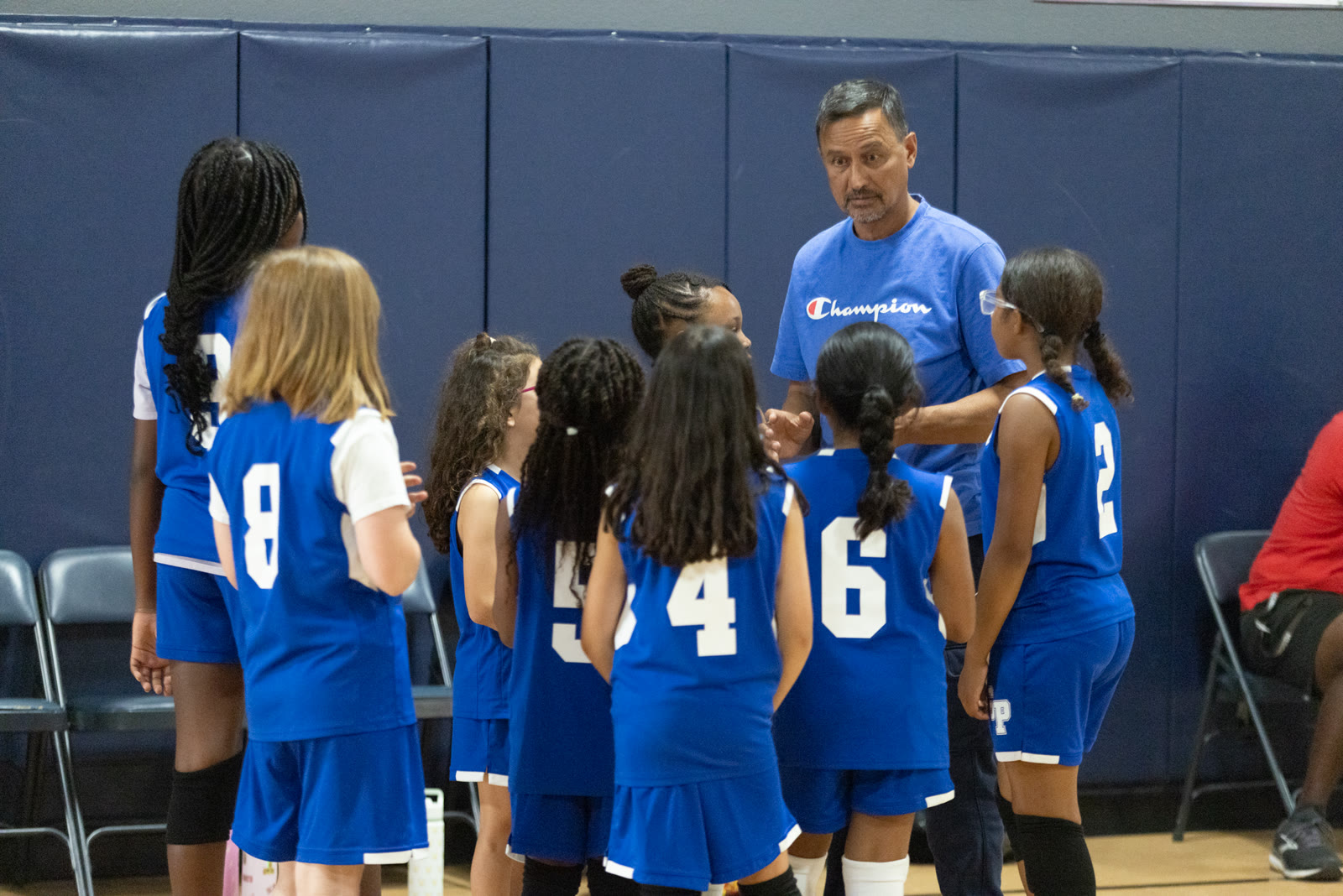 GPS volleyball team huddle with their coach